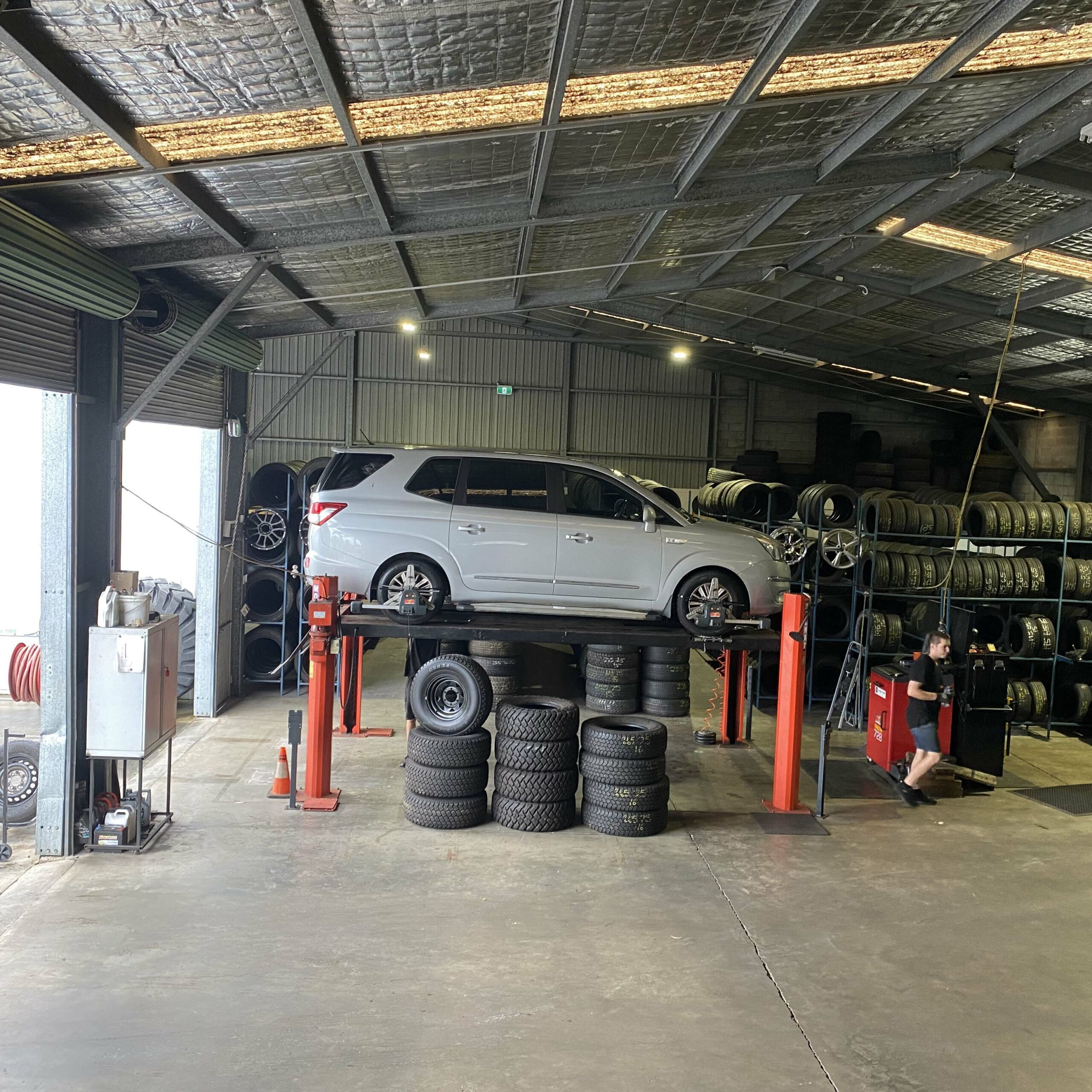 Car on jack at the Branigans Burleigh Heads tyre shop.