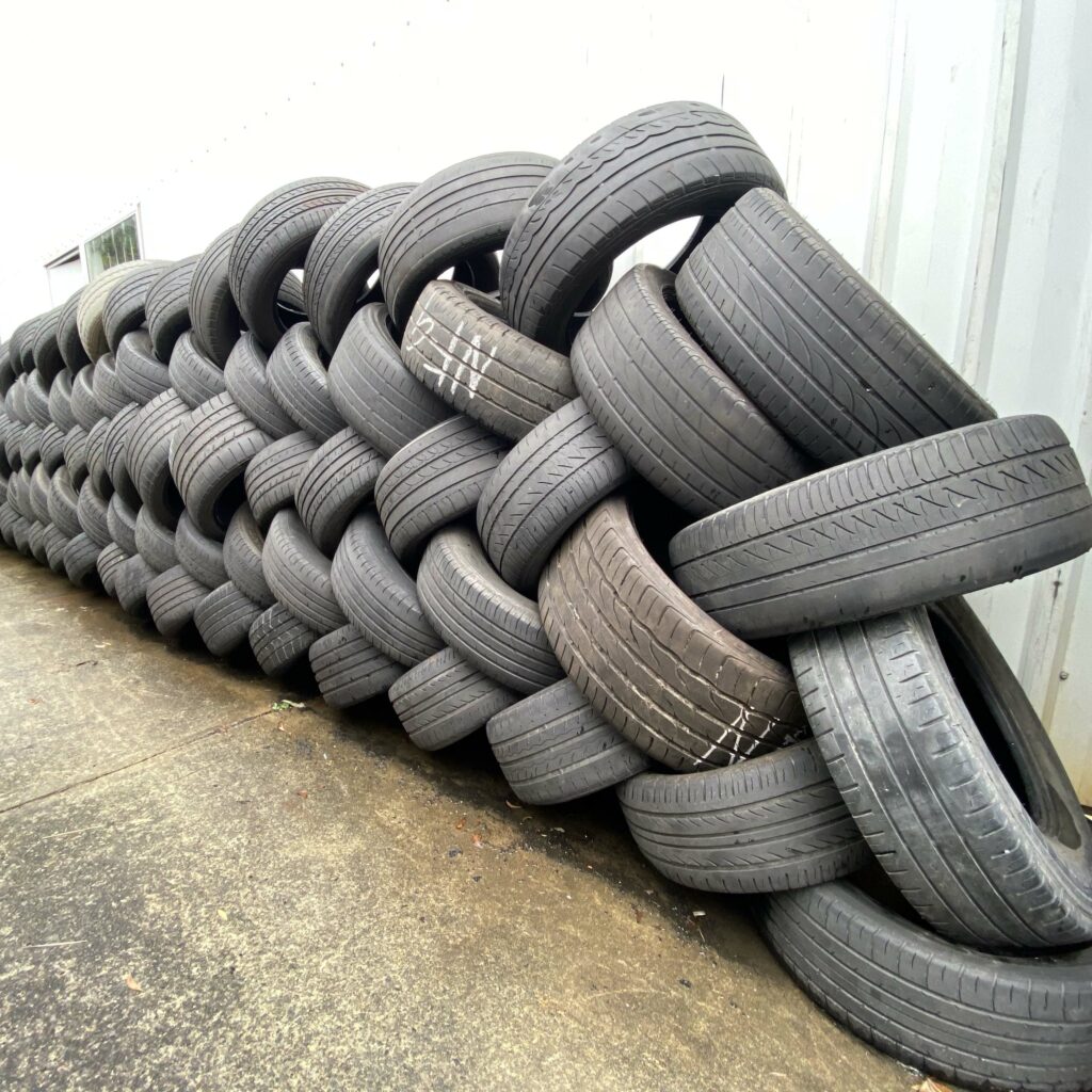 Tyres stacked up against the wall of the Branigans Burleigh Heads tyre shop in the Gold Coast