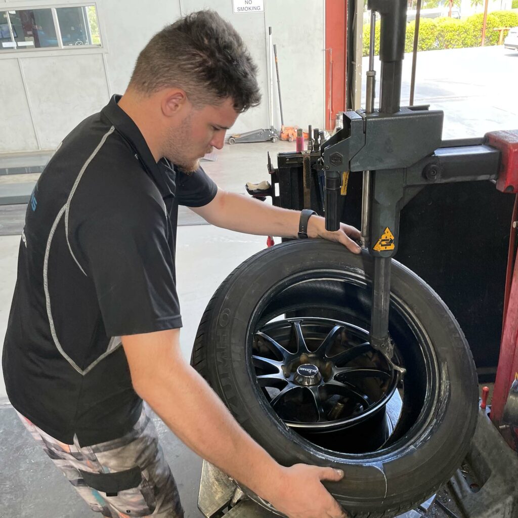 Staff removing tyre at the Branigans Southport tyre shop in the Gold Coast.
